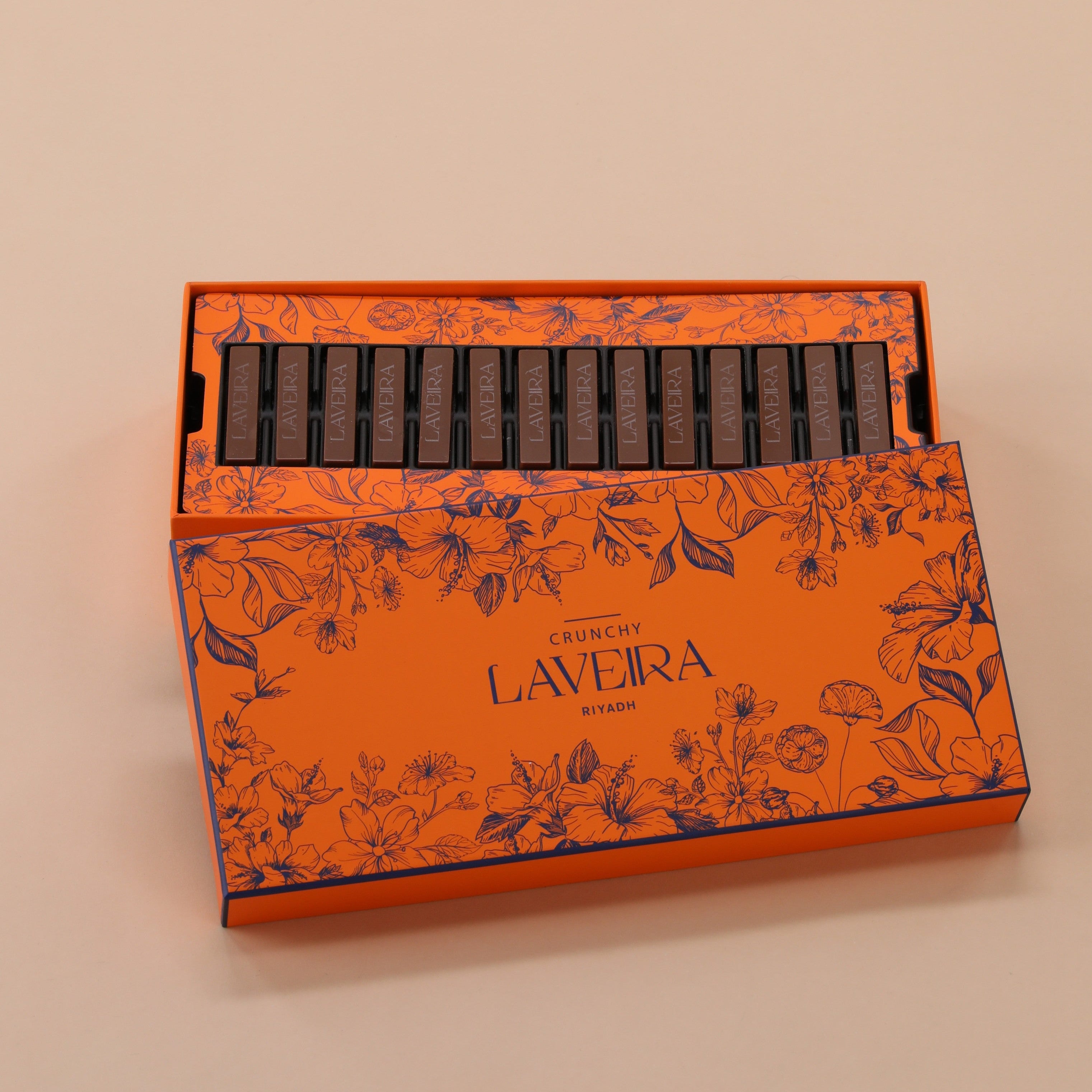 Orange box with black text and floral design on a beige background